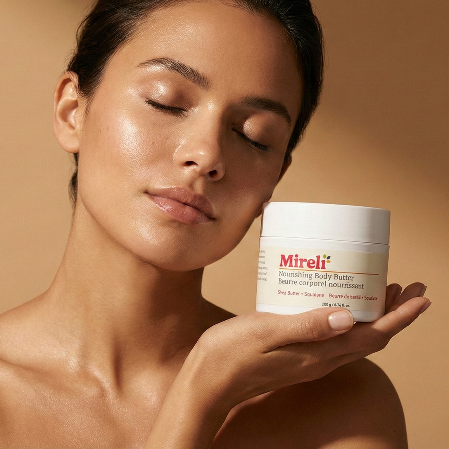 Woman holding a jar of Mireli body butter against a beige background